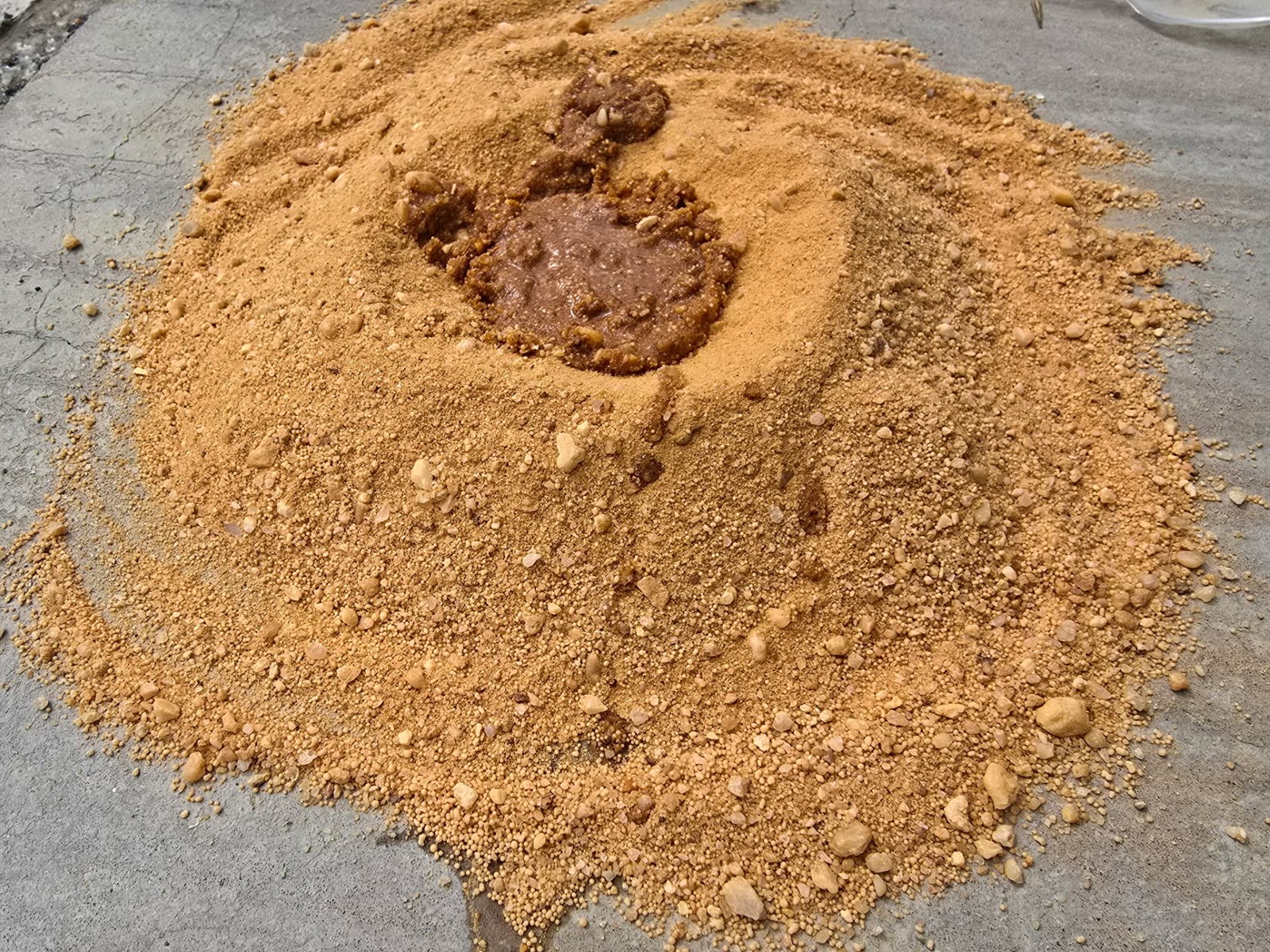 Pile of Remedia-O with oil bonded in a crater at the center, not spreading outward.